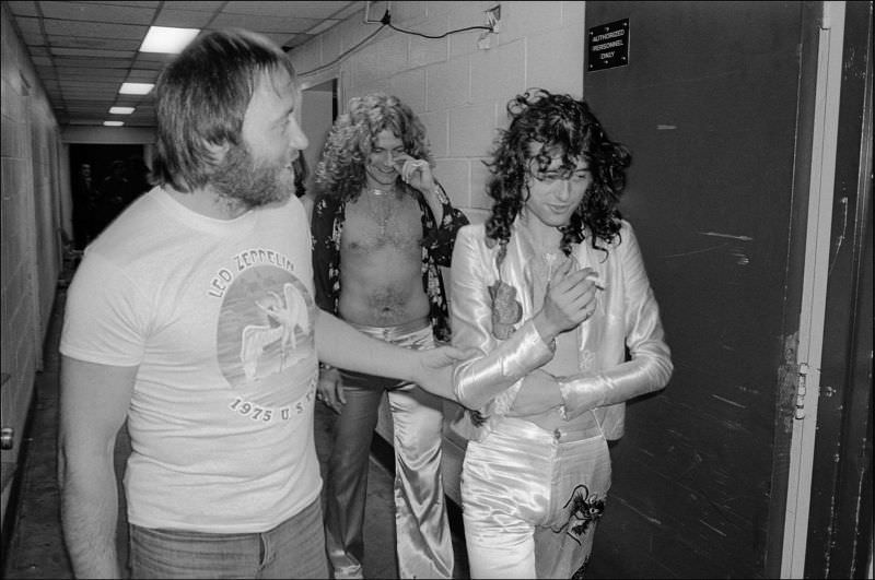 Jimmy Page (fore, right) and Robert Plant (center, rear) as they walk backstage at Madison Square Garden, New York, New York, June 10, 1977