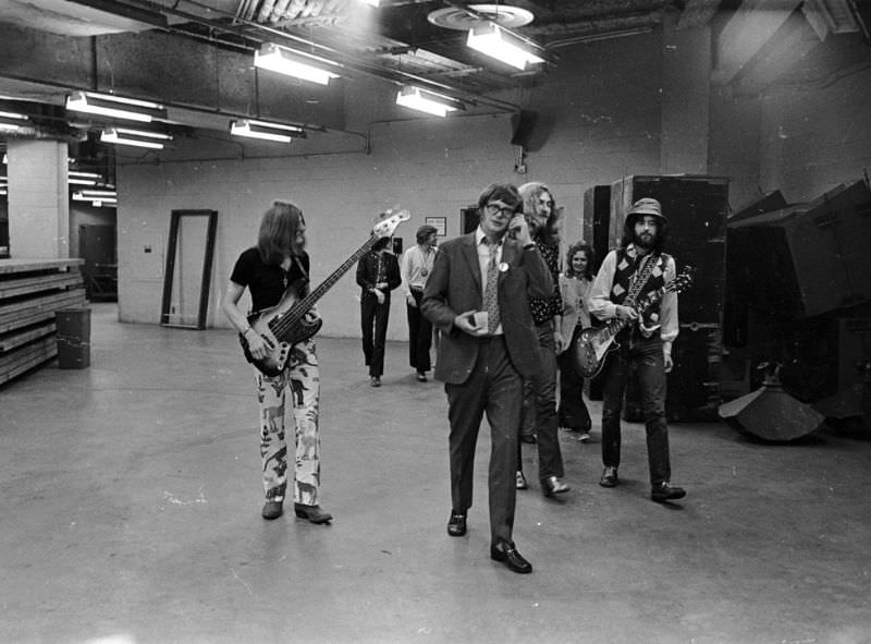 Led Zeppelin's bassist, John Paul Jones, singer, Robert Plant, and guitarist, Jimmy Page, walk backstage at the Forum in Los Angeles in 1977