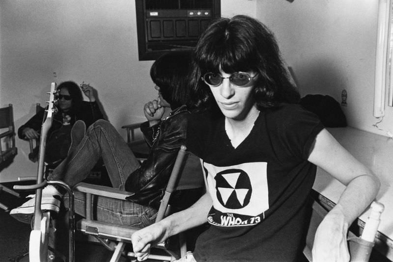 Joey Ramone backstage at the Paradise Theater (now the Paradise Rock Club) in Boston, Massachusetts, March 22, 1978. In the background are bassist Dee Dee Ramone and drummer Tommy Ramone