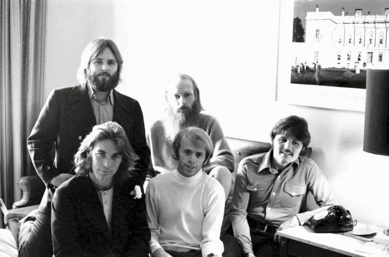 The Beach Boys pose in a green room backstage before a concert in December 1970