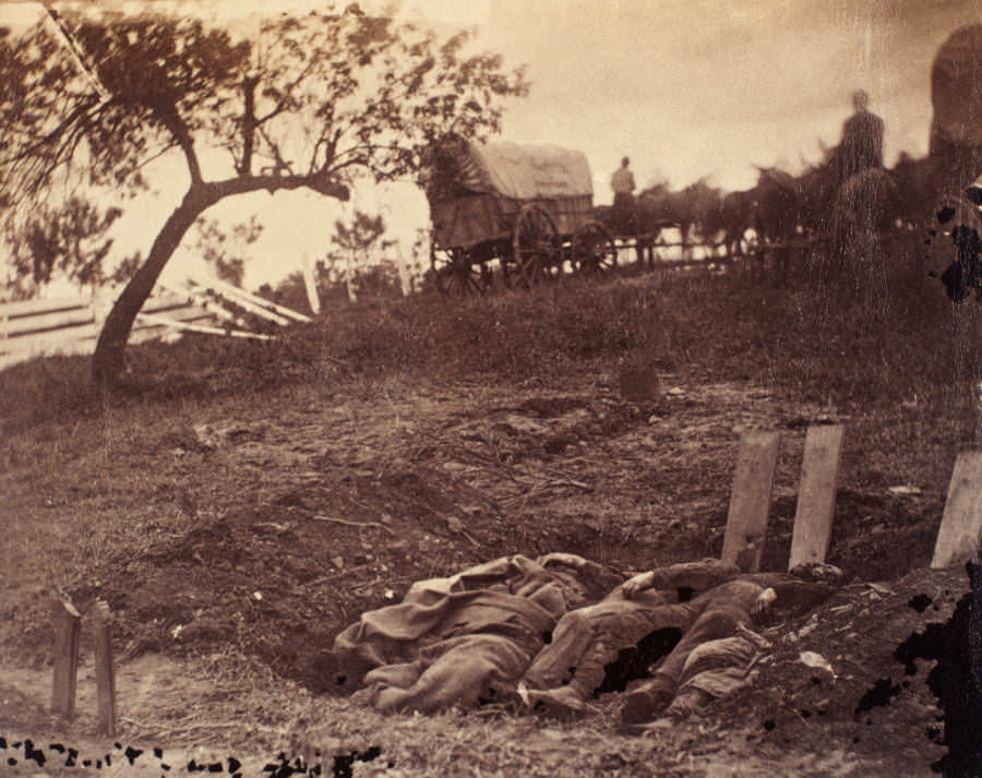 The bodies of a group of Confederate soldiers wait to be buried.