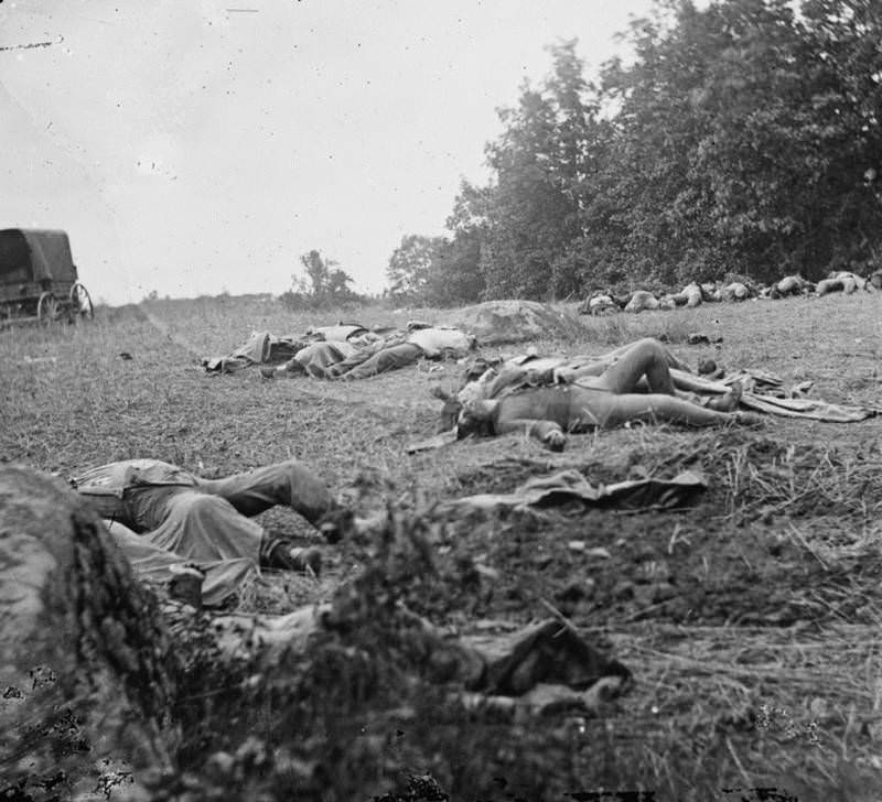 The bodies of Confederate dead are gathered for burial.