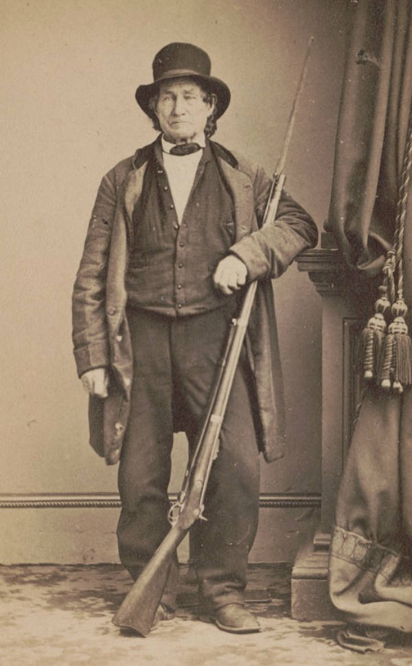 John L. Burns, a civilian who fought alongside the Union at the Battle of Gettysburg, poses for a photo with his musket.