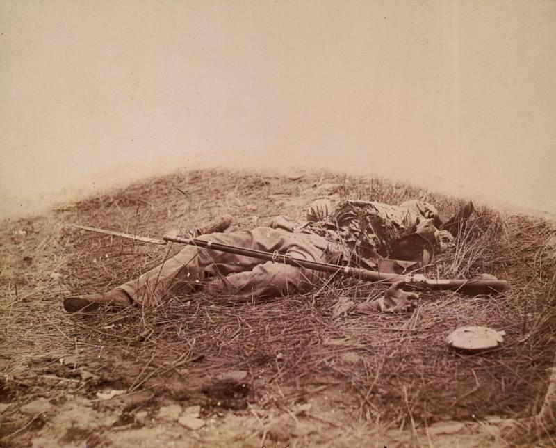 A Union soldier who was torn apart by artillery lies dead on the ground.