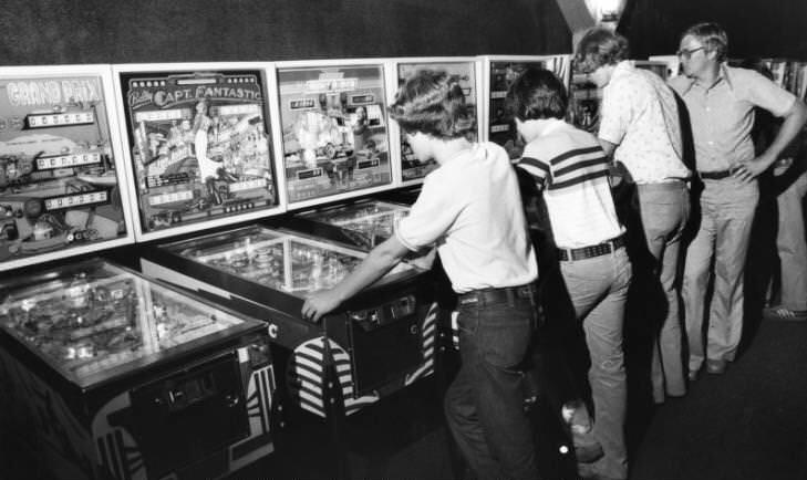 Arcade goers playing on pinball machines at Cumberland Mall in Atlanta, Georgia, 1978