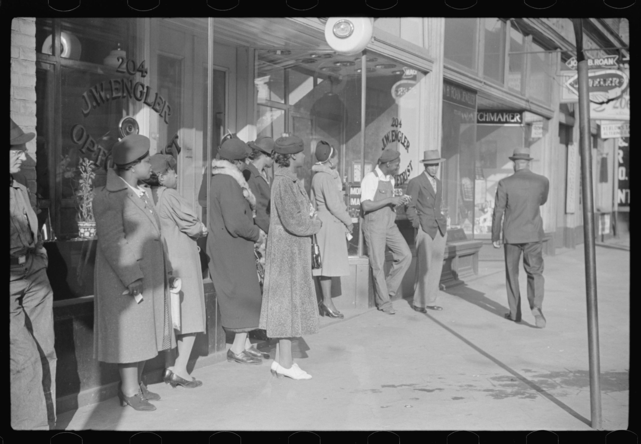 Domestic servants waiting for streetcar on way to work early in the morning. Mitchell Street, Atlanta, Georgia. May, 1939