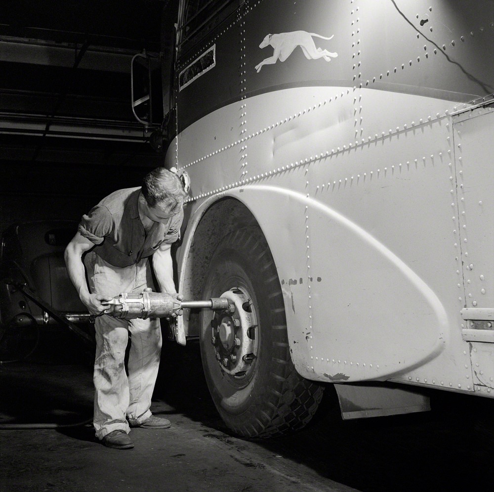 Removing a tire from a bus at the Greyhound garage, Pittsburgh, September 1943