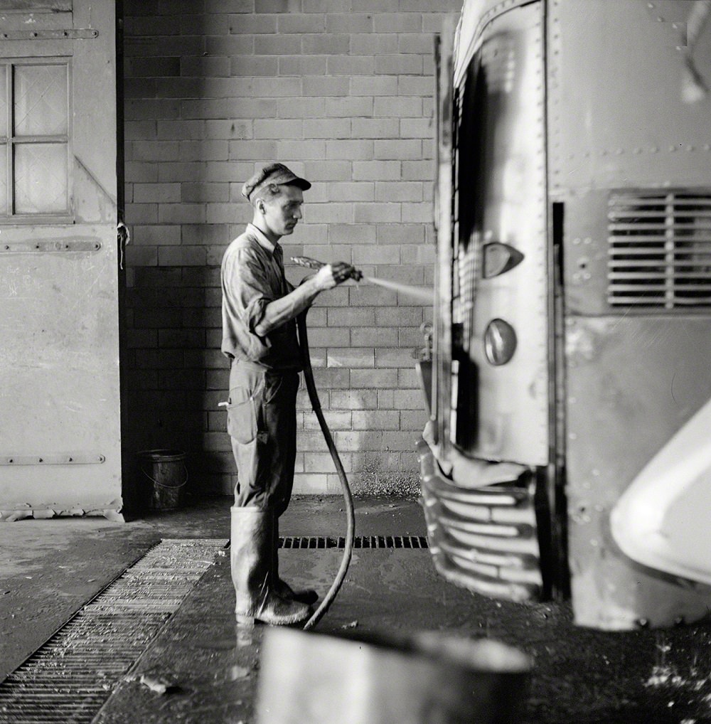 Bus serviceman washing a coach which has just come in from a run in the Greyhound garage, Pittsburgh, September 1943
