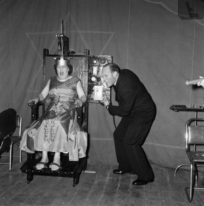 A man electrocuting his wife for a fairground sideshow. Boston, Lincolnshire, 1957