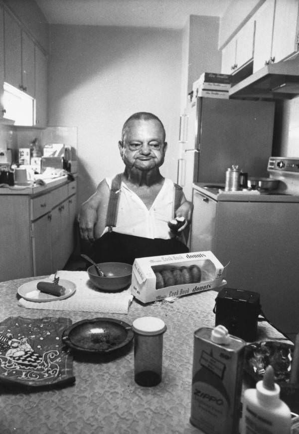 "Sealo the Sealman," a retired sideshow performer, enjoying a donut for breakfast, 1960