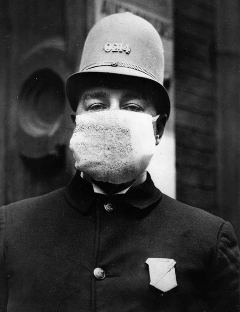 An American policeman wears a 'flu mask' to protect himself from the Spanish flu outbreak that followed World War I, 1918