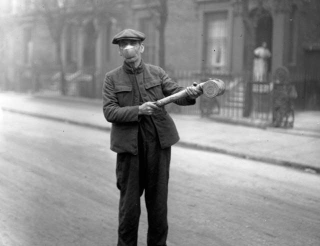 A U.S. Red Cross employee wears a face mask in an attempt to help decrease the spread of influenza, 1918