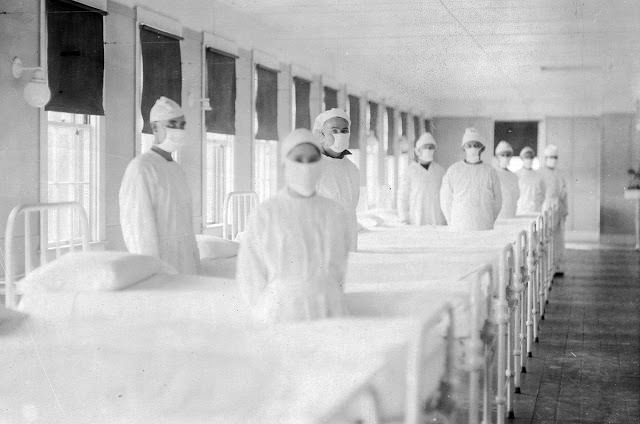 Corpsmen in caps and gowns ready to attend patients in the influenza ward of the U.S. Naval Hospital on Mare Island, California, on December 10, 1918.