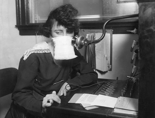 A telephone operator wears protective gauze in 1918.