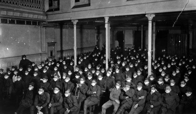 Recovering soldiers watch a motion picture show wearing flu masks at U.S. Army Hospital Number 30 in Royat, France.