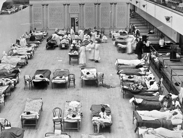 Volunteer nurses from the American Red Cross tend to influenza patients in the Oakland Municipal Auditorium, used as a temporary hospital in 1918.