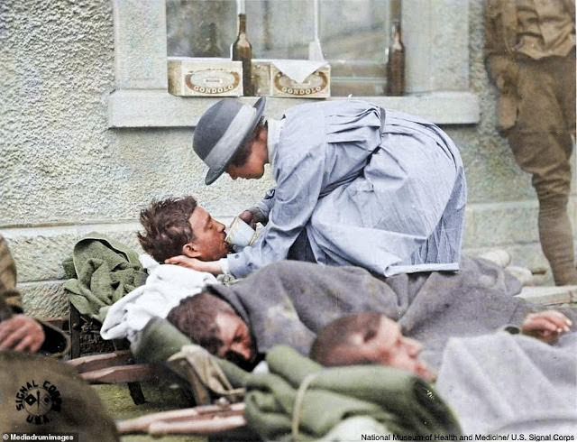 American Red Cross nurse aiding wounded soldiers at Montmirail, France, May 31, 1918.