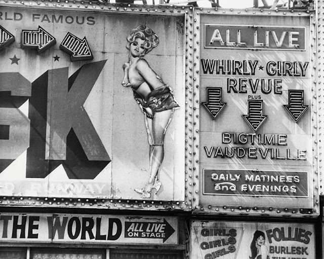 The 'Whirly Girly Revue' and 'Bigtime Vaudeville' strip club signs at the 'Follies Burlesk' on 46th St. and Broadway, New York City, 1978.