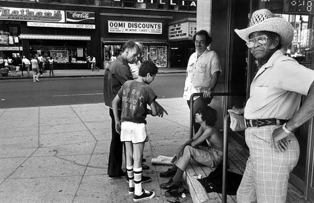 Child prostitutes talk with chicken hawks, men who buy sex with boy prostitutes, in Times Square.