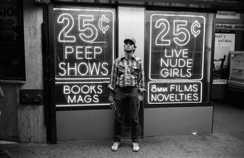 Actor Bill Murray poses in front of the famous 25-cent peep shows of Times Square in the mid-1970s.