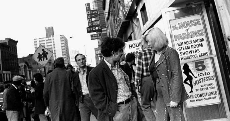 People converse in front of the infamous "House of Paradise."