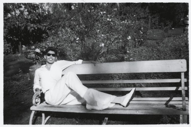 Freddie Mercury enjoying on bench