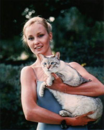 A young Jessica Lange holding a fat cat, 1970s