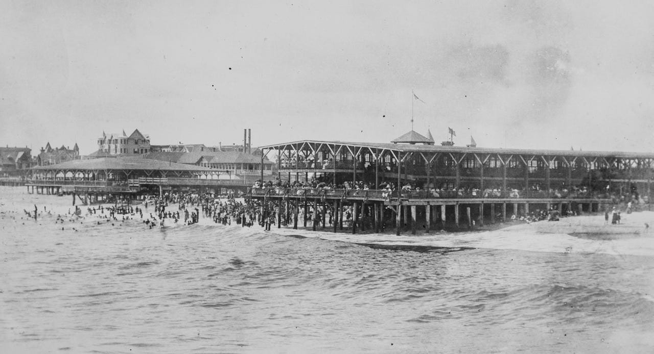 The old wooden pavilion in Asbury Park to the right, 1901. The pavilion on the left was the Ocean Grove Rose pavilion