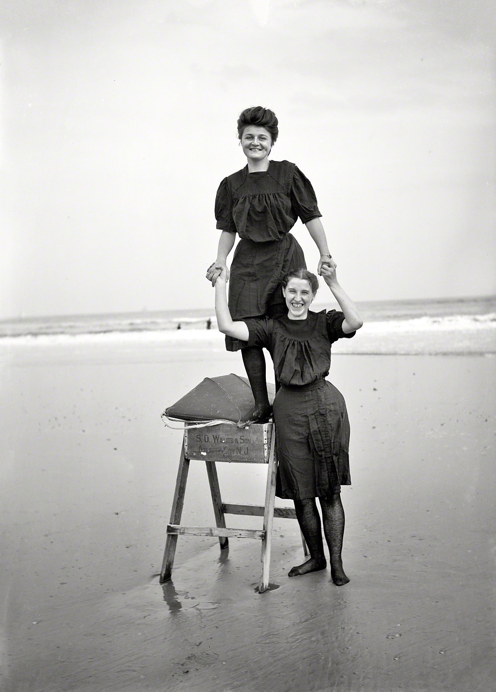 Bathing beauties playing on sawhorse, 1905