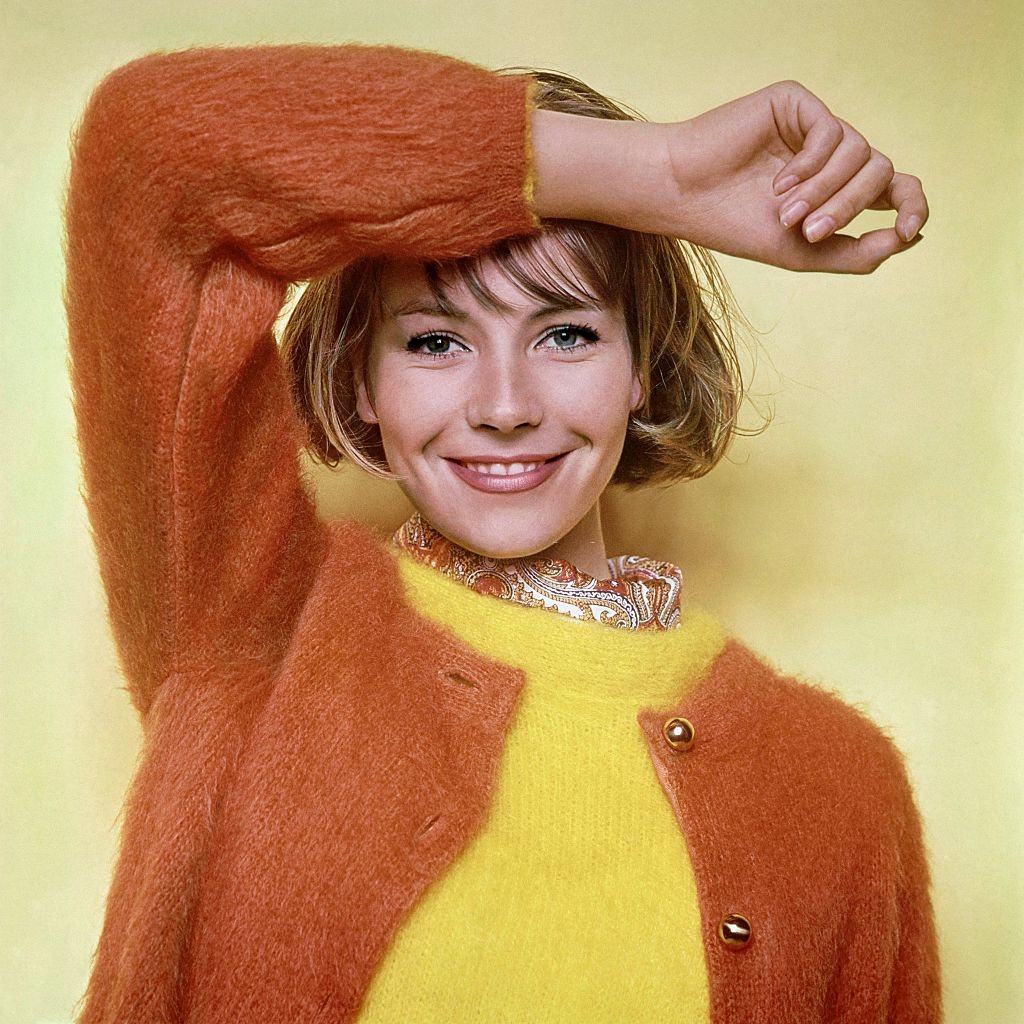 Model Kyra wearing mohair sweaters, slipover and cardigan, Glamour 1961