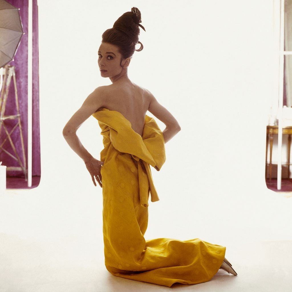 Audrey Hepburn wearing a strapless yellow silk evening dress, Vogue 1963