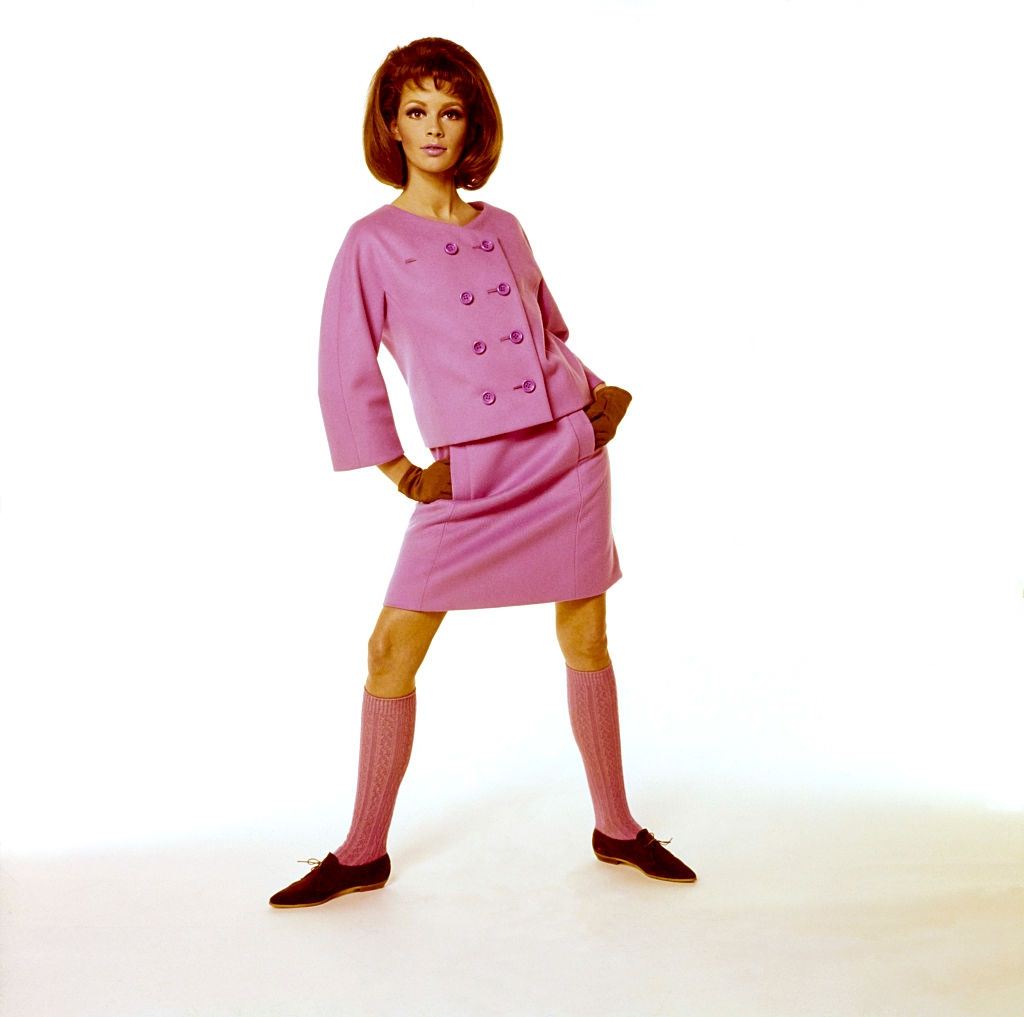 Model wearing pink skirt suit with double breasted jacket, Vogue 1964