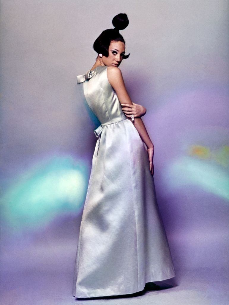 Model Marisa Berenson wearing a long blue evening dress with a bell skirt, Vogue 1965