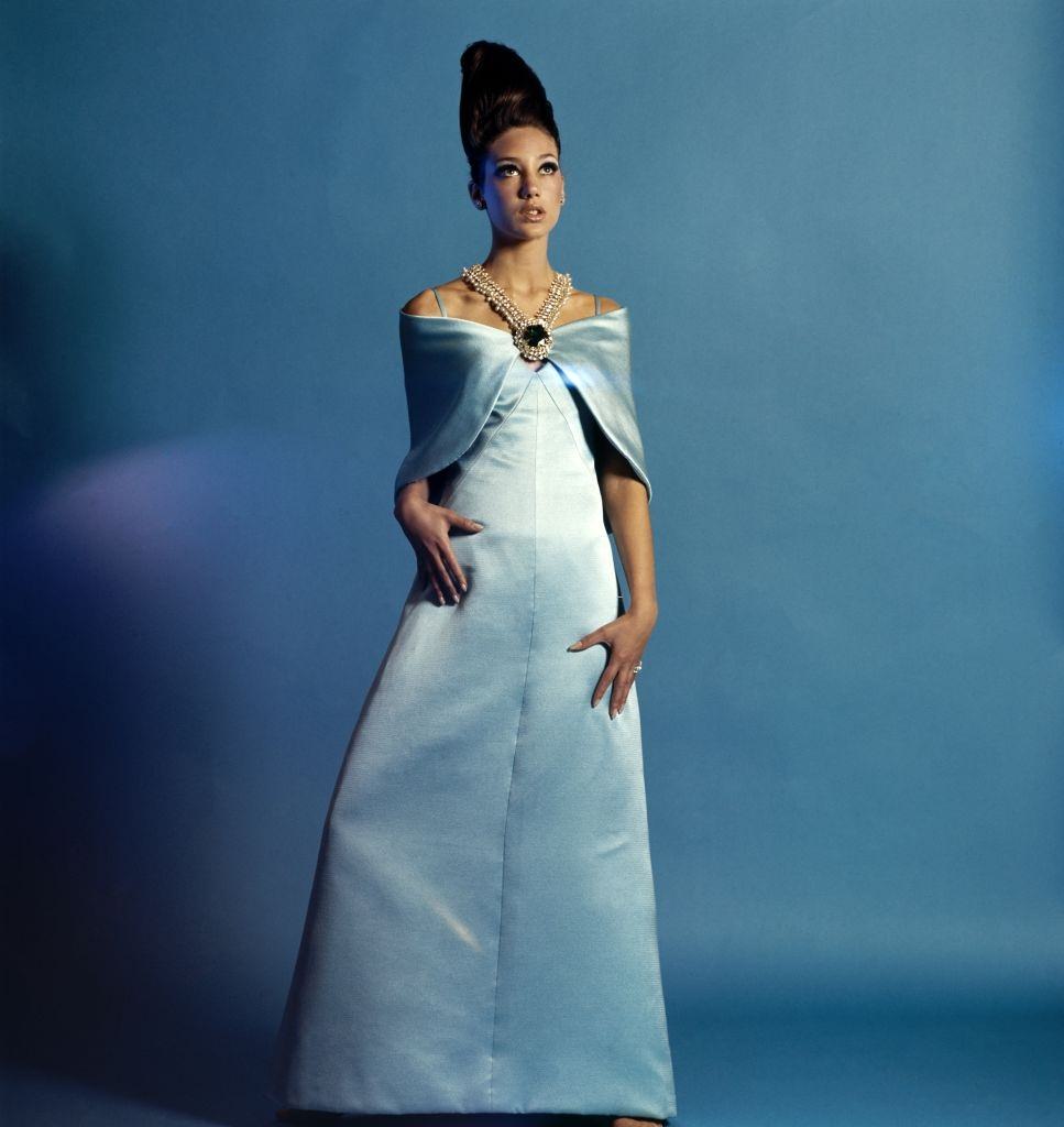 Model Marisa Berenson in a Adele Simpson gown and shawl with Schreiner jewelry, Vogue 1965