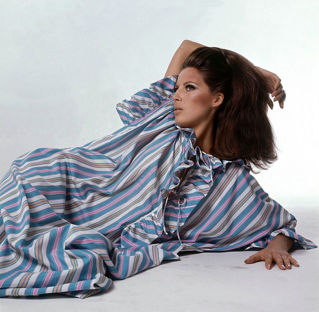 Model wearing striped ruffled jibba by Fernando Sanchez for Warners, Vogue 1966