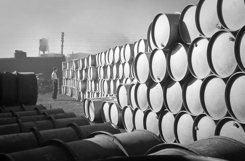 A workman studies a massive drum farm at the Proctor and Gamble factory, July 15th, 1939