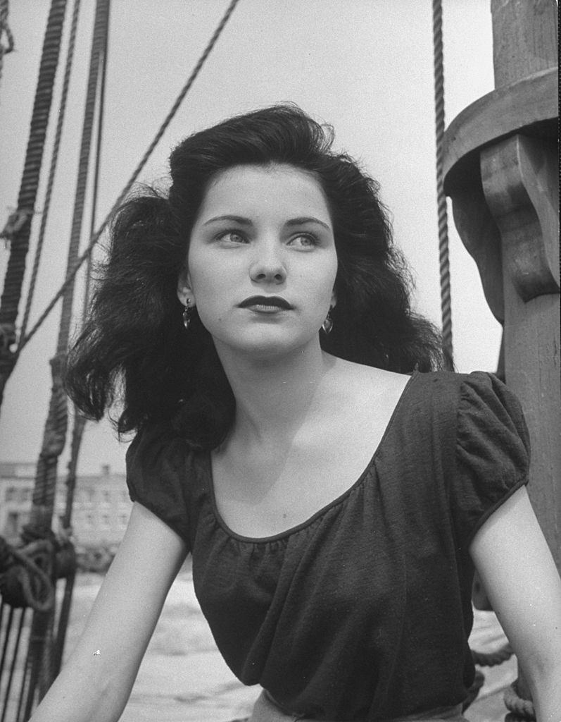 Debra Paget, posing on a dock.