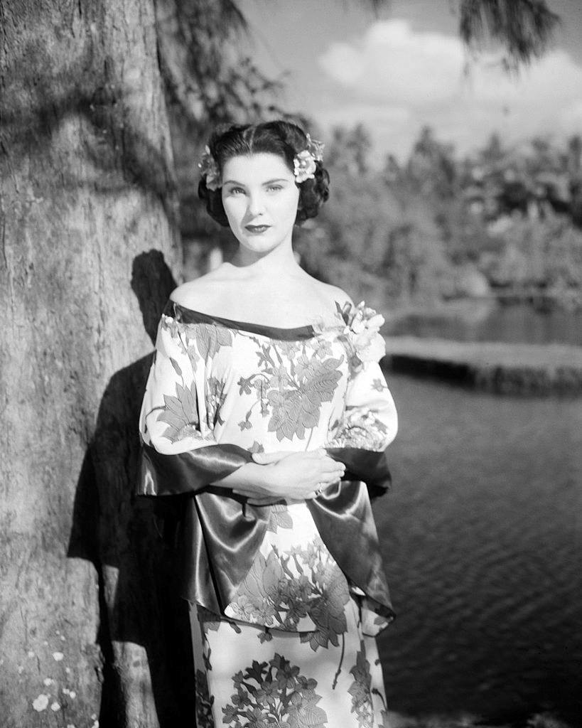 Debra Paget wearing a silk, oriental-style dress, 1950