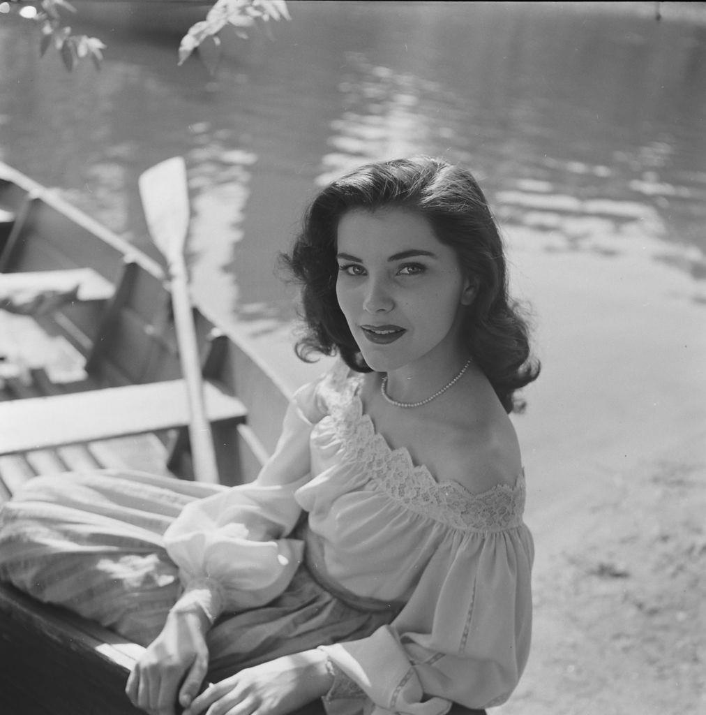 Debra Paget, sitting on a boat in the United States, 1950