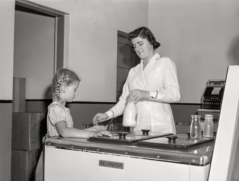 Child buying bottle of milk from Duluth Milk Company, Duluth, Minnesota, August 1941