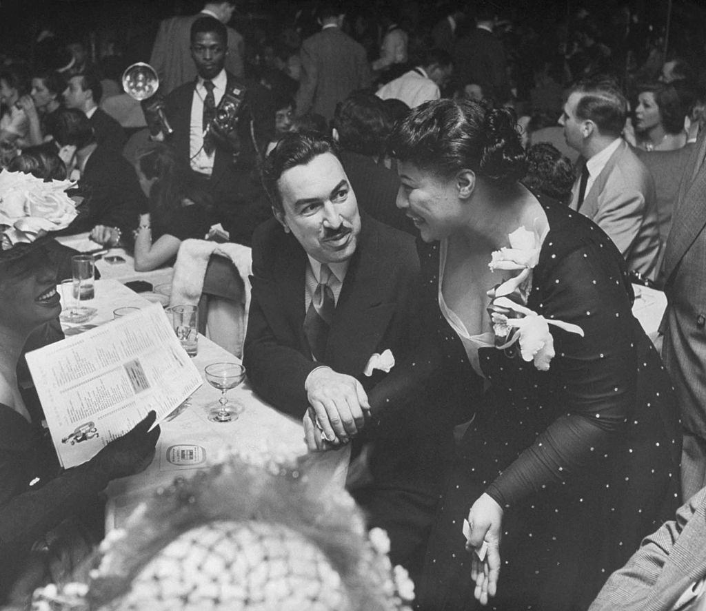 Ella Fitzgerald singing behind mike at opening at Bop City, 1949