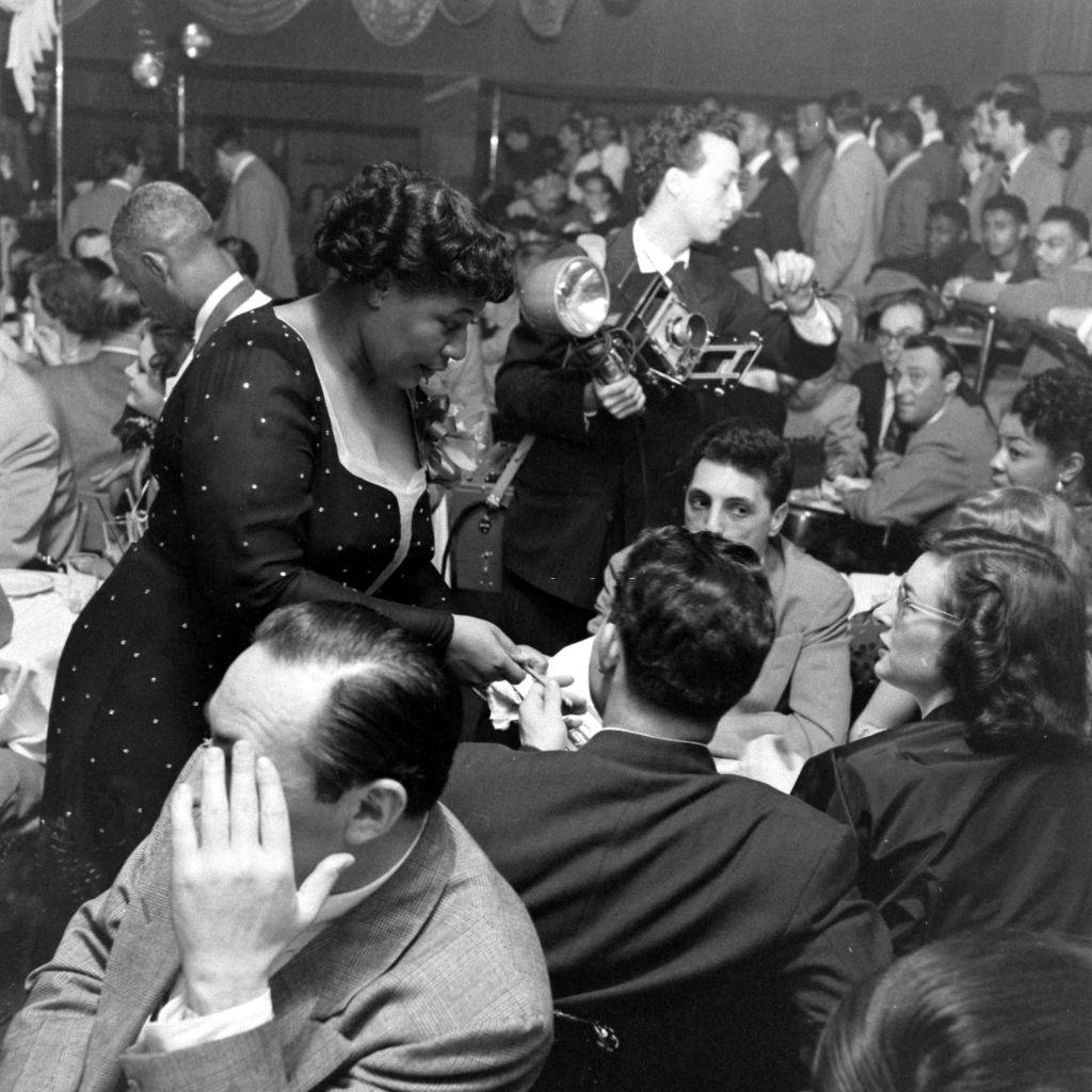 Ella Fitzgerald mingling with people during opening night of Bop City nightclub in New York City, New York, April 1949