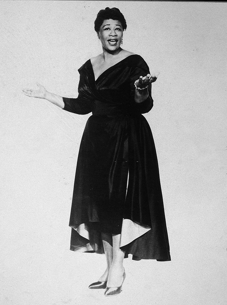 Ella Fitzgerald singing and wearing a dark evening dress, 1950s