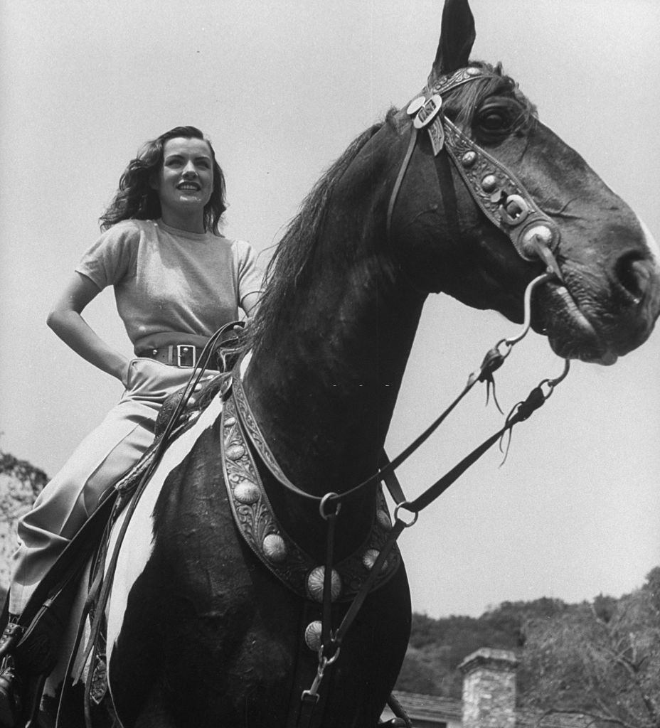 Ella Raines riding a horse, 1940s