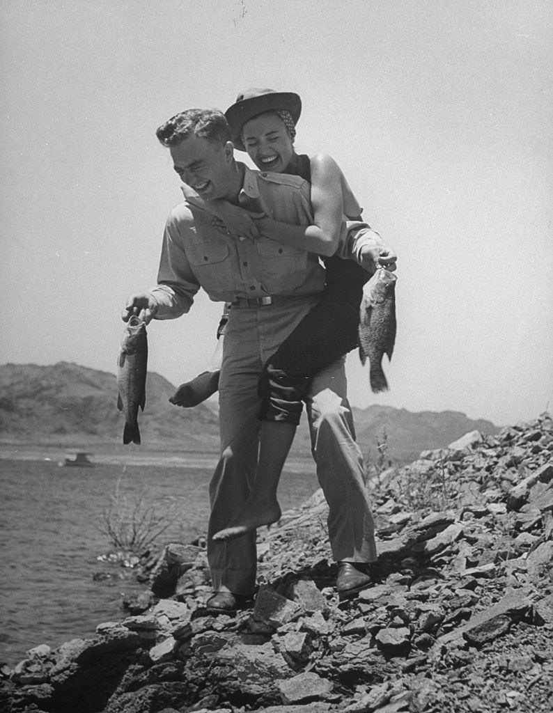 Ella Raines riding piggy-back on her husband Major Kennth Trout.
