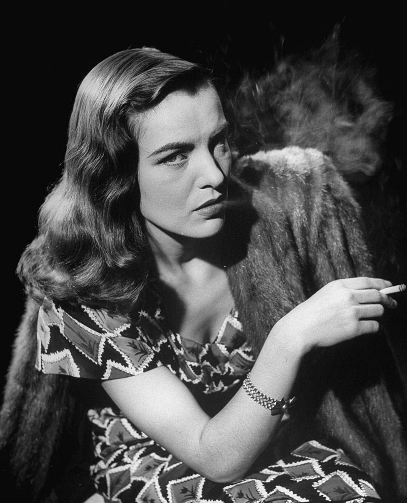 Ella Raines smoking a cigarette in the motion picture Brute Force