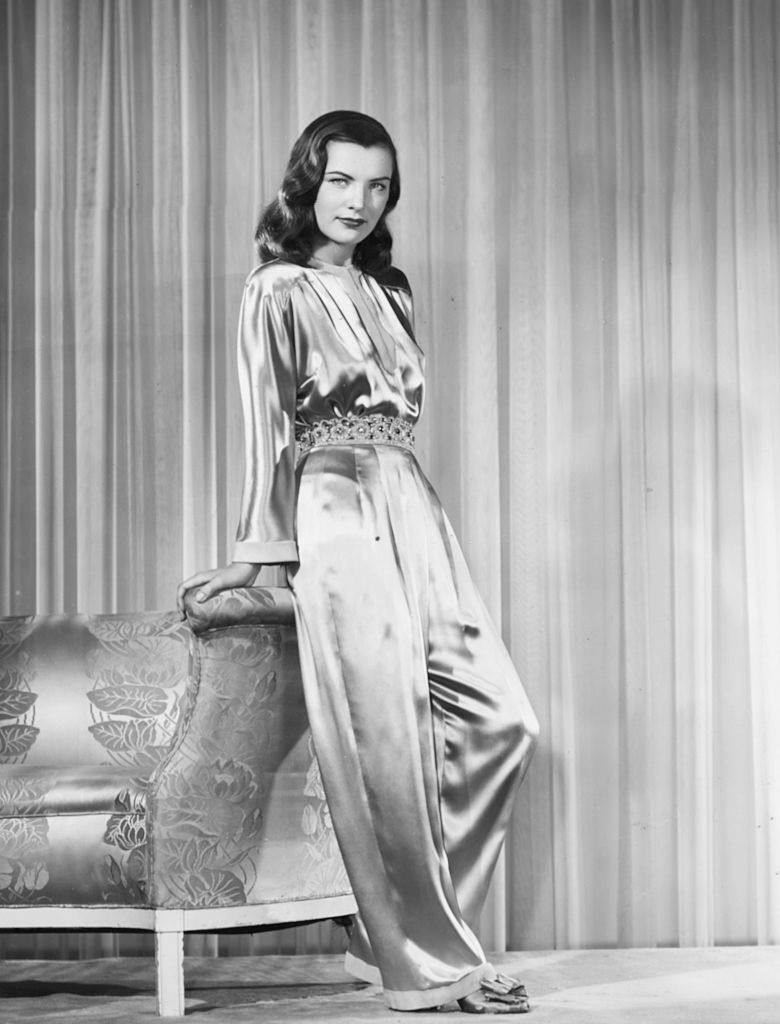Ella Raines wearing an ivory, satin jumpsuit, circa 1943.