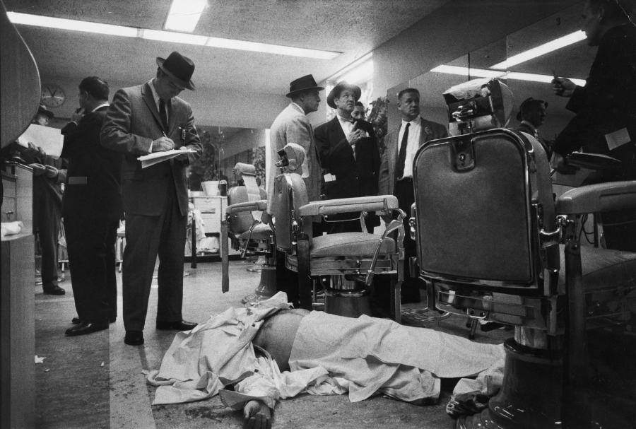 Police examine the murder scene of infamous mafioso Albert Anastasia, gunned down in the barbershop of the Park Sheraton Hotel, 1957