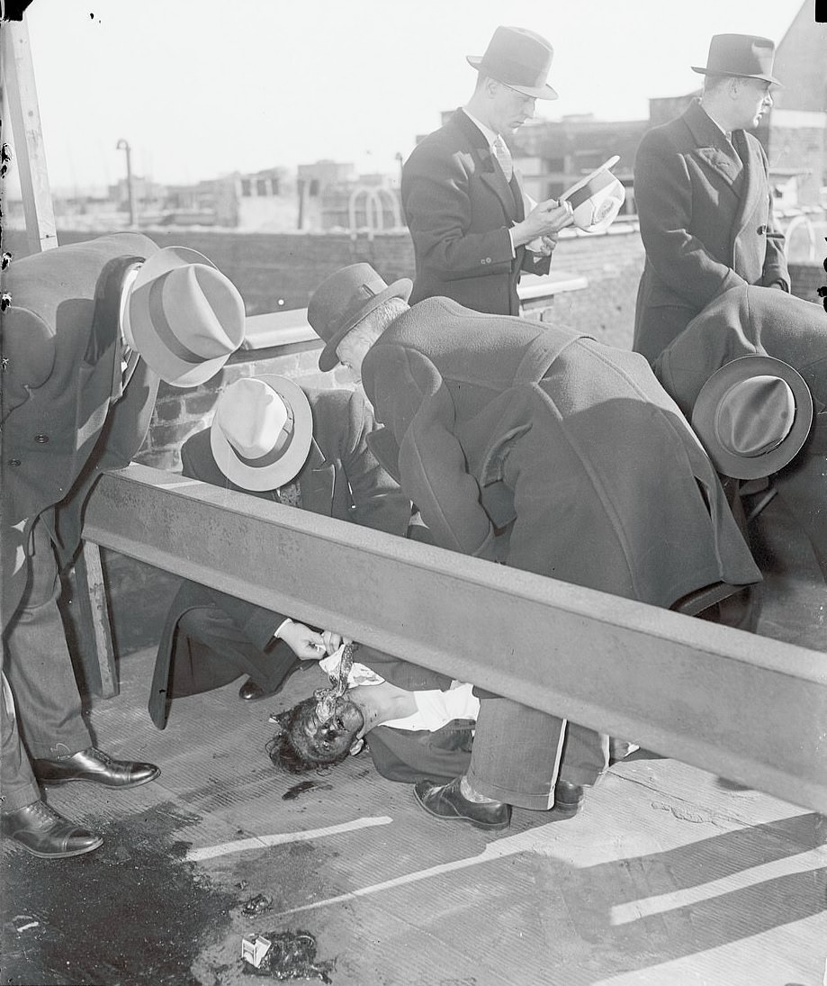 Homicide squand and a group of detectives examining an unidentified body in New York City in 1935