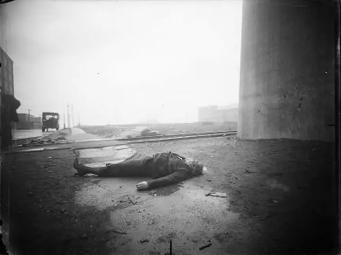 A woman's body found in the Bronx next to a concrete structure. Trolley tracks can be seen in the background, June 24, 1917